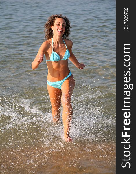 Young woman runs on water, summer
