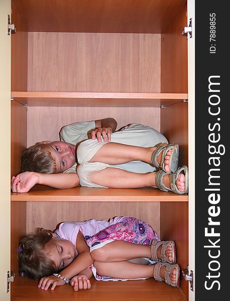 Two children sleeps on shelves
