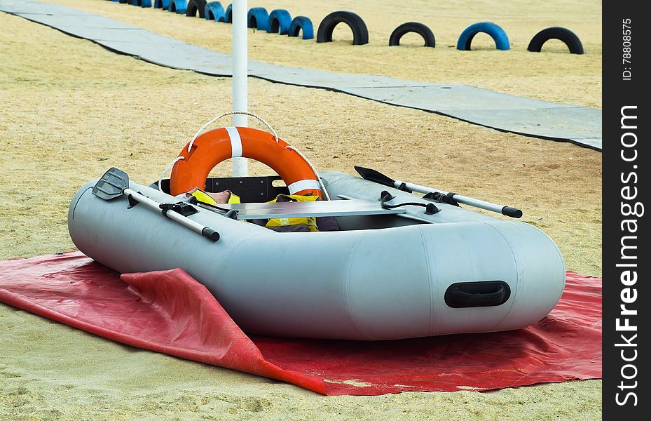 Inflatable Rescue Boat. Gray inflatable boat on the beach in the sand