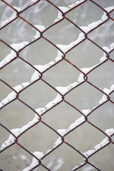 Rusty Wire Fence Under Snow Stock Image