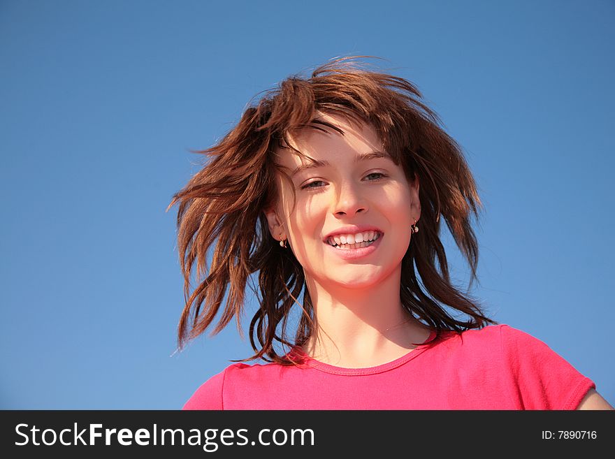 Young girl on blue sky background