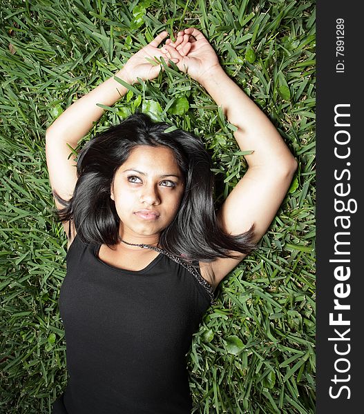 Beautiful young teen laying on green grass. Beautiful young teen laying on green grass