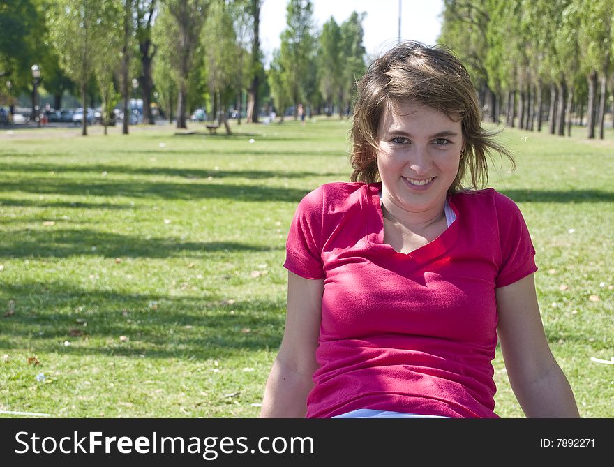 Portrait of a teenage girl sitting on a bench and smiling. Portrait of a teenage girl sitting on a bench and smiling