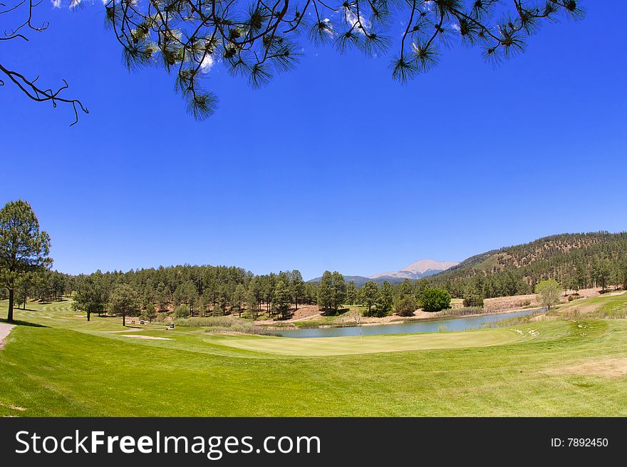 An image of a Arizona golf course with lush vegetation and mountain peaks. An image of a Arizona golf course with lush vegetation and mountain peaks