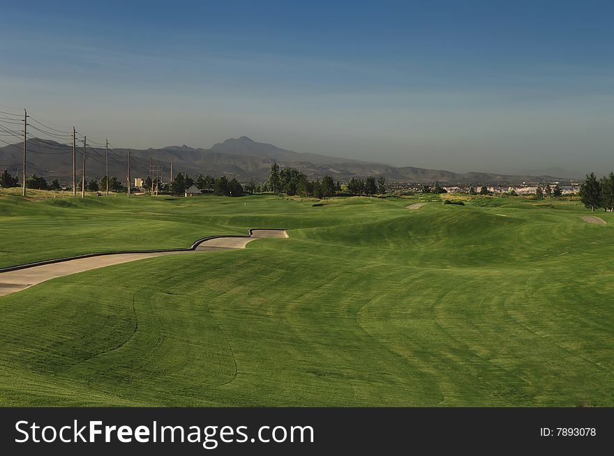 Lush green fairway grass with mountains in the background. Lush green fairway grass with mountains in the background