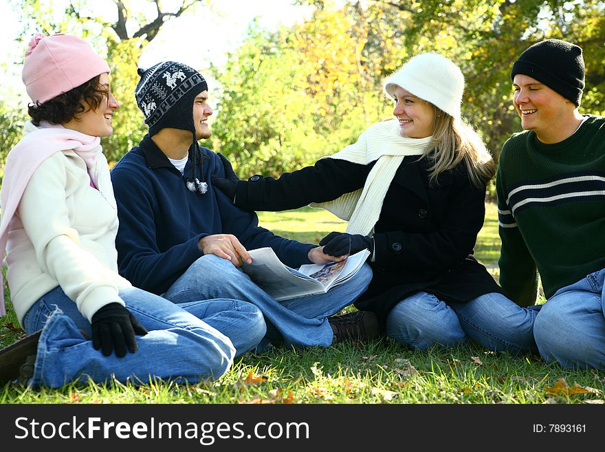 Four young caucasian male and female talking and having fun in park. Four young caucasian male and female talking and having fun in park