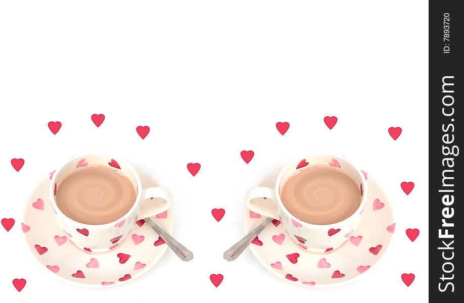 Shot of two cups of hot drink on white with hearts. Shot of two cups of hot drink on white with hearts