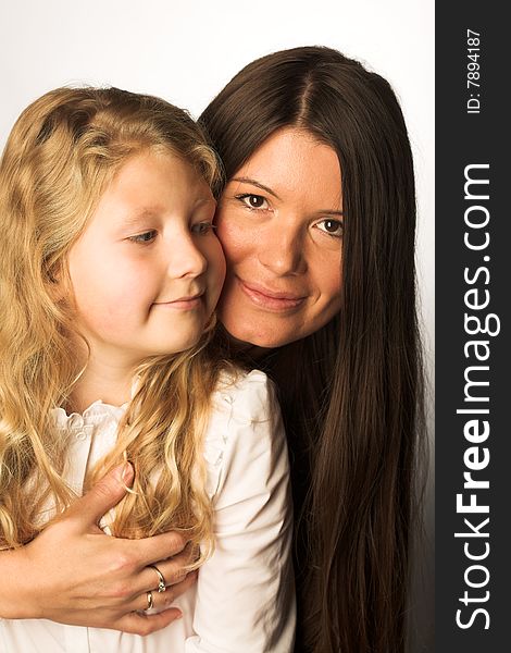 Young mother and daughter, studio shot,