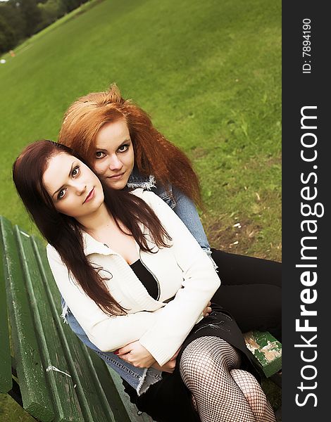 Close-up portrait of two girl-friends during their walk in park. Close-up portrait of two girl-friends during their walk in park