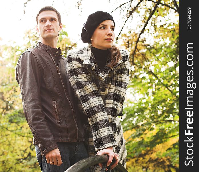 Young and beautiful husband and wife walking in an autumnal park. Young and beautiful husband and wife walking in an autumnal park