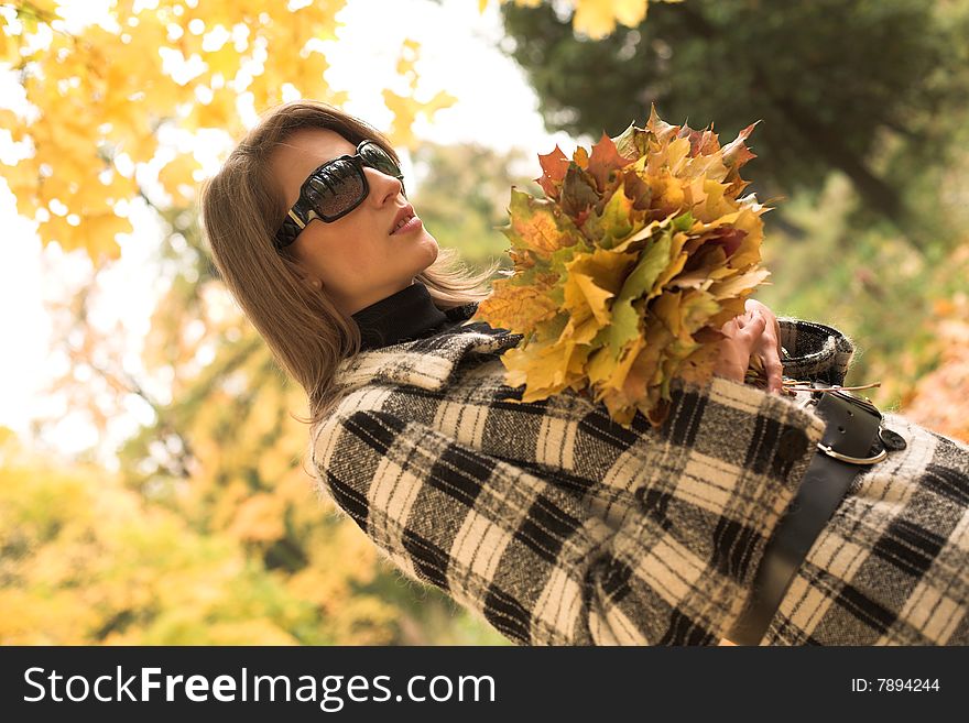 Young beautiful woman walking in autumnal park. Young beautiful woman walking in autumnal park