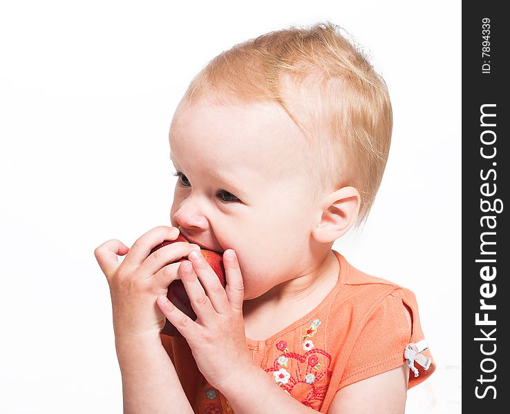 Studio portrait of a little girl eating an apple. Studio portrait of a little girl eating an apple