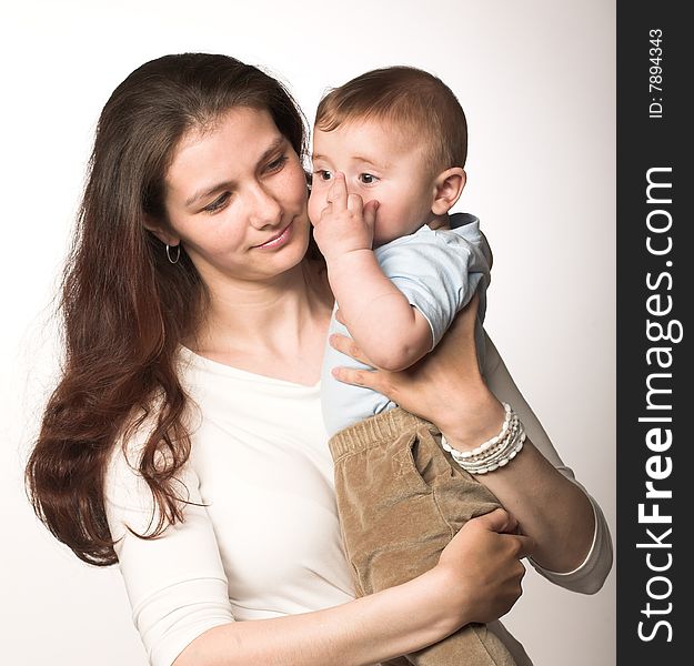 Studio portrait of a young mother with her child. Studio portrait of a young mother with her child