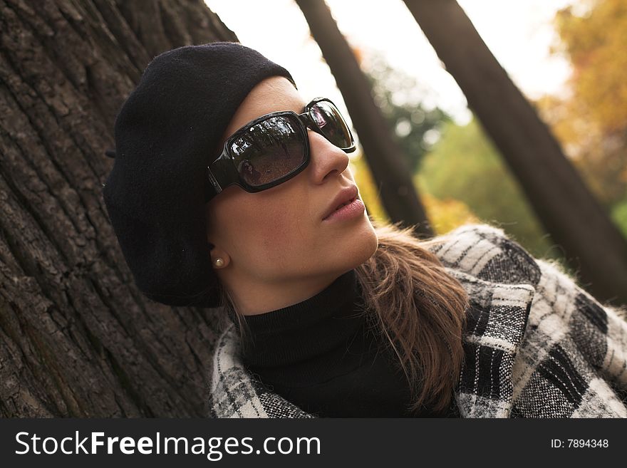 Young beautiful woman walking in autumnal park. Young beautiful woman walking in autumnal park