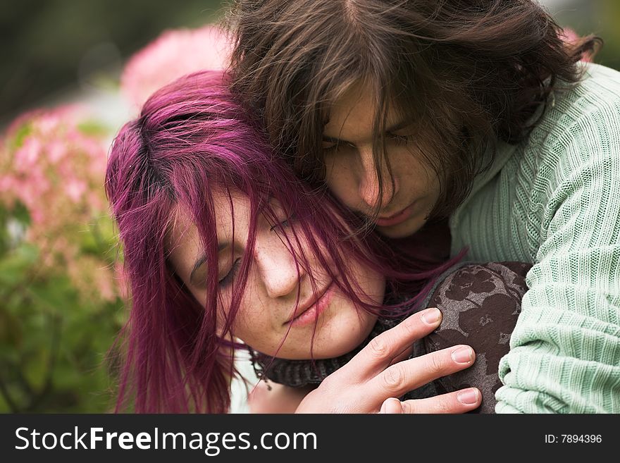 Attractive man and woman couple in love in the park. Attractive man and woman couple in love in the park