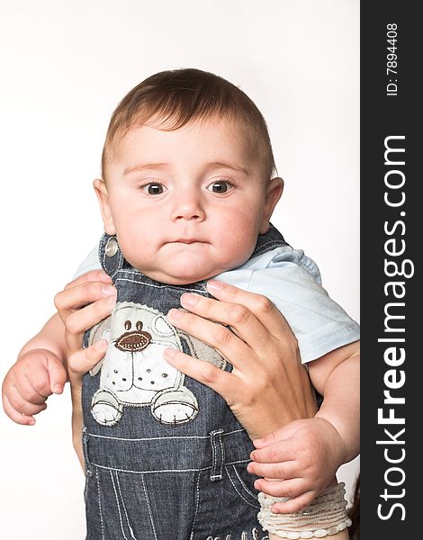 Close-up studio portait of a cute child holding by his mother