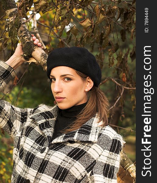 Young woman in autumnal park