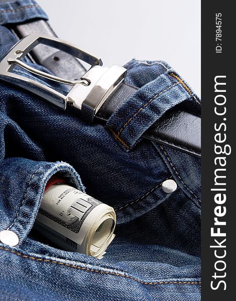 American dollars in blue jeans pocket with balck belt. American dollars in blue jeans pocket with balck belt