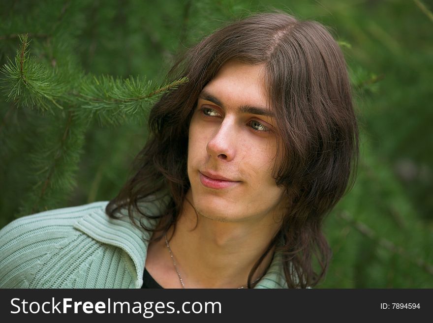 Portrait of a handsome young man during his walk in a park