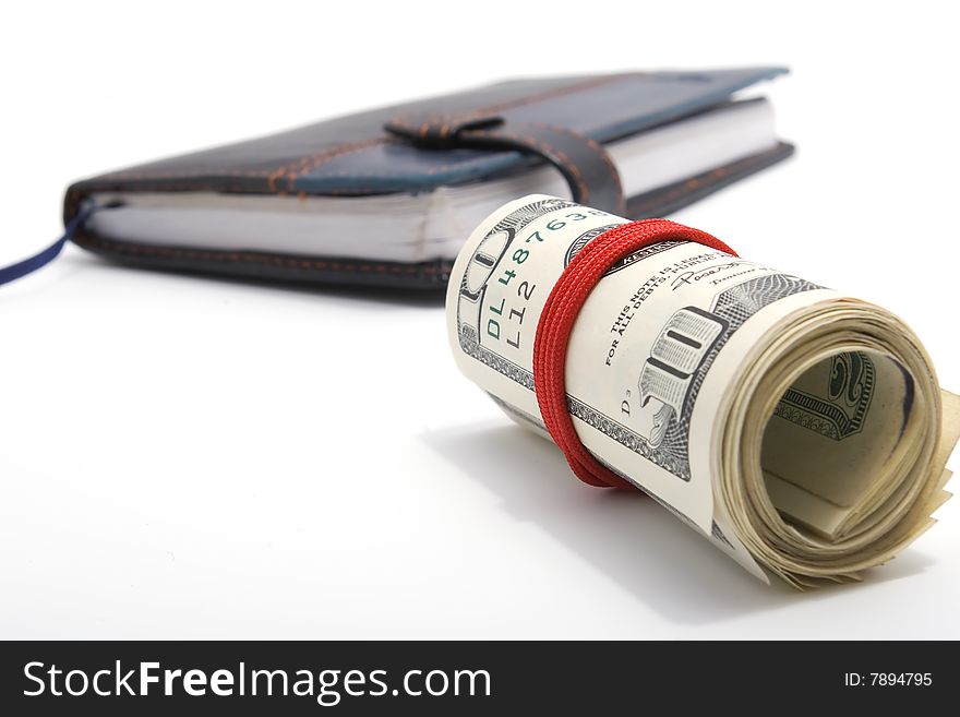 American dollars and leather notebook on white background with shadows