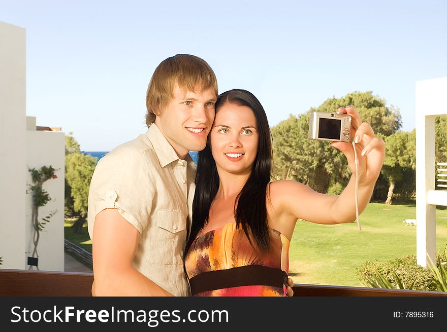 Young couple taking a photo of themselves on the balcony