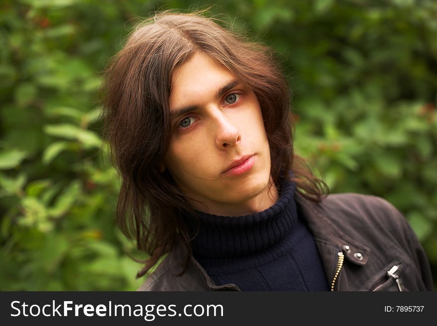 Portrait of a handsome young man during his walk in a park