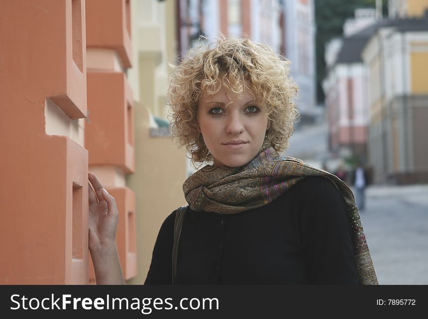 Curly girl walking in city. Curly girl walking in city