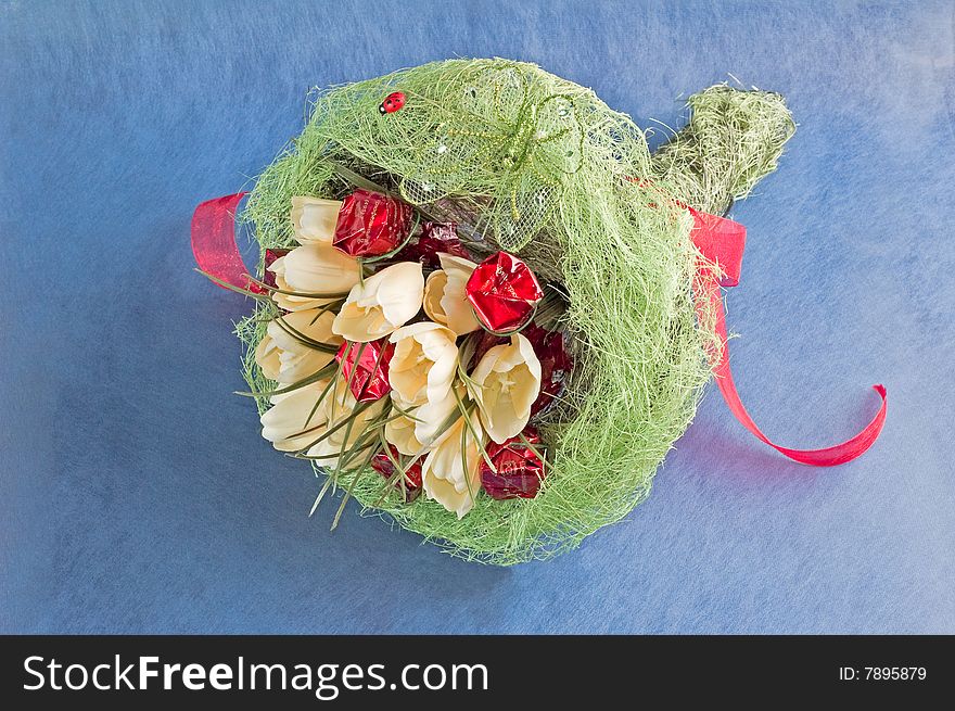 Photo of bouquet of artificial flowers isolated on blue textured background