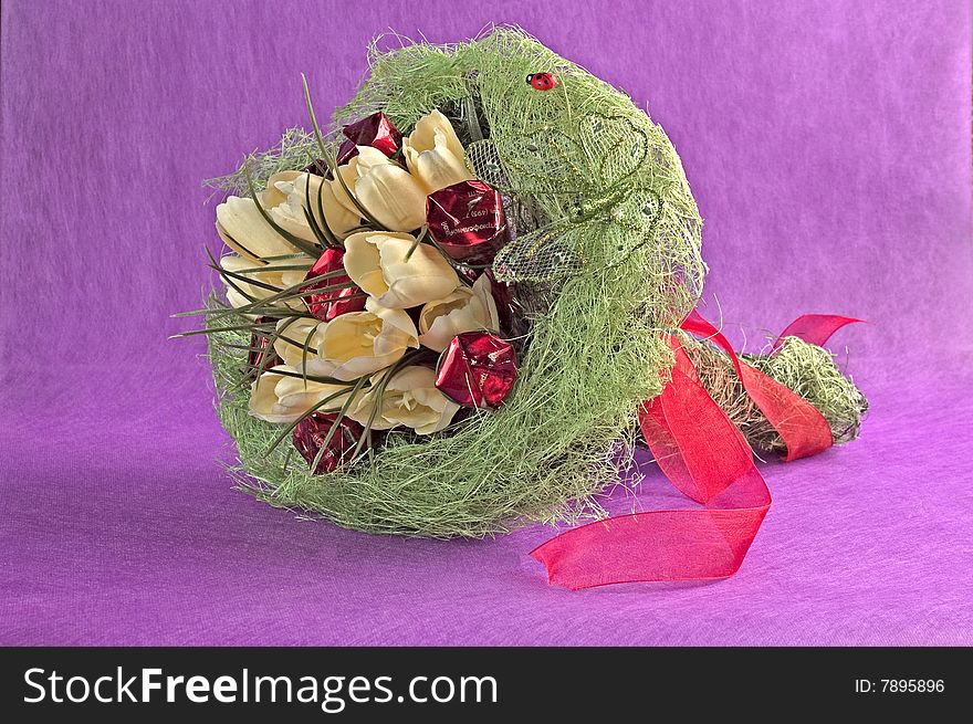 Photo of bouquet of artificial flowers isolated on red textured background