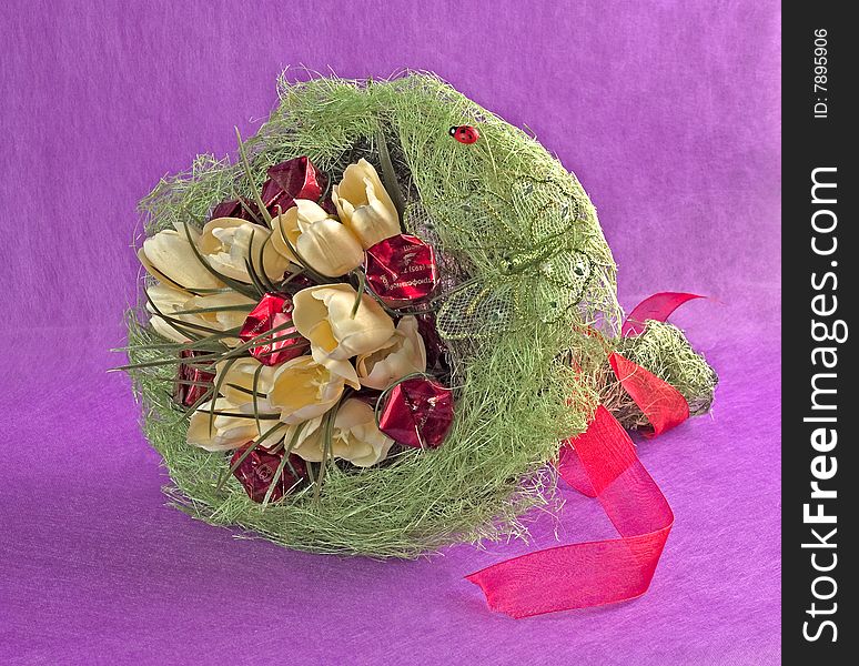 Photo of bouquet of artificial flowers isolated on red textured background