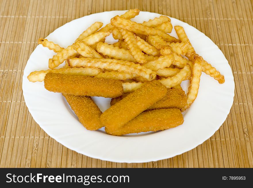 French fries and fish sticks on table