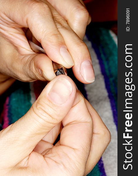 A girl making manicure using clippers