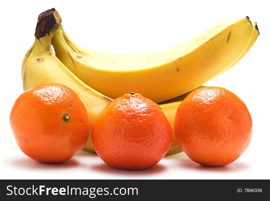 Bundles of bananas and three tangerines isolated on a white background. Bundles of bananas and three tangerines isolated on a white background.