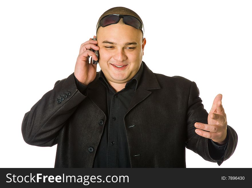 Man in black suit in sun glasses talking on the mobile phone. Isolated on white background