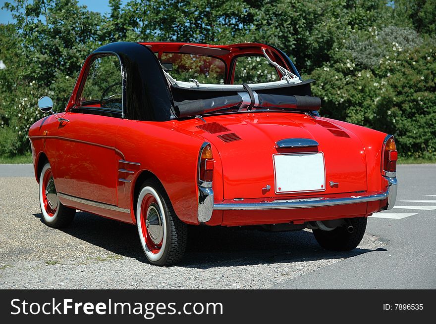 Parked small red sports car. Parked small red sports car