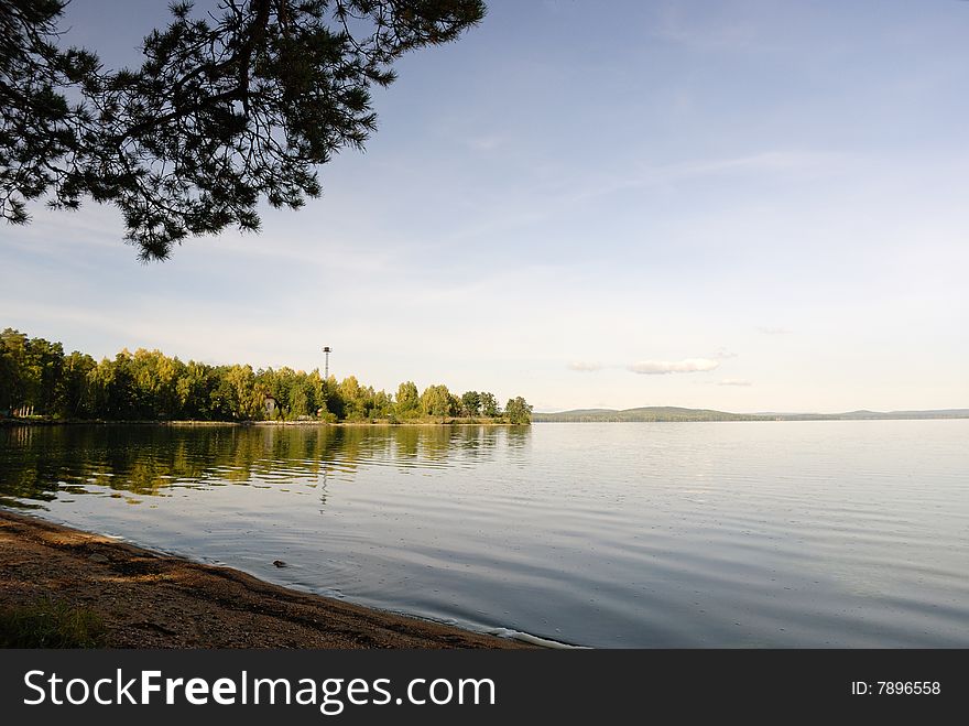 Autumnal beach, lake, sand and water