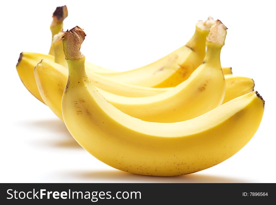 Several bananas isolated on a white background. Background blurred. Several bananas isolated on a white background. Background blurred.