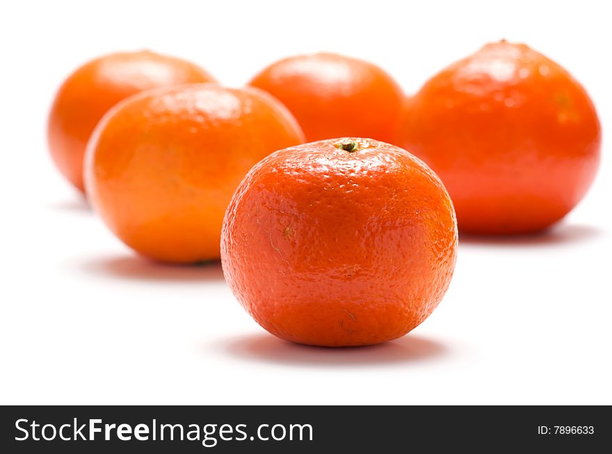 Several tangerines are isolated on a white background. Background blurred.