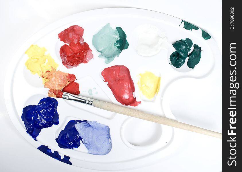 Palette with paints and paintbrush