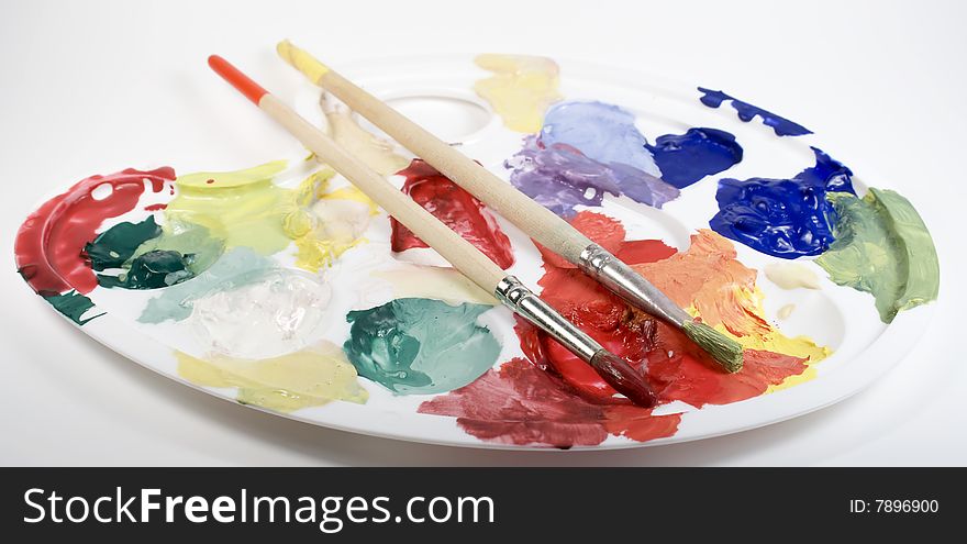 Palette with paints and two paintbrushes