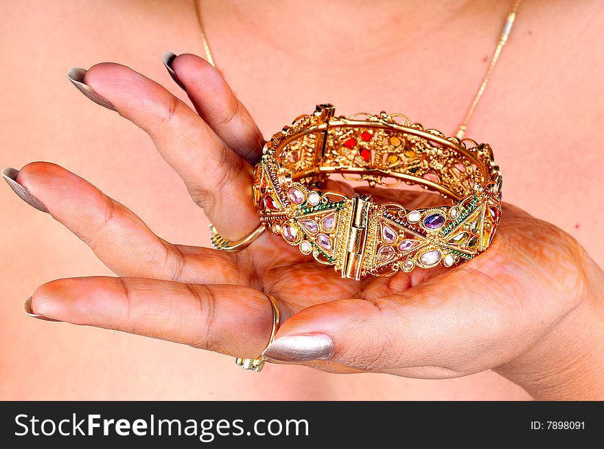 Golden bracelet on models hand.