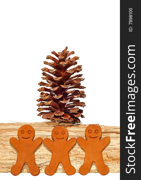 Gingerbread Men Against Firewood with a Pine Cone. Gingerbread Men Against Firewood with a Pine Cone