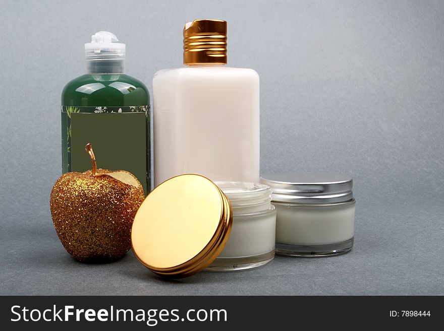Different beauty products with apple flavor on grey background. Different beauty products with apple flavor on grey background.