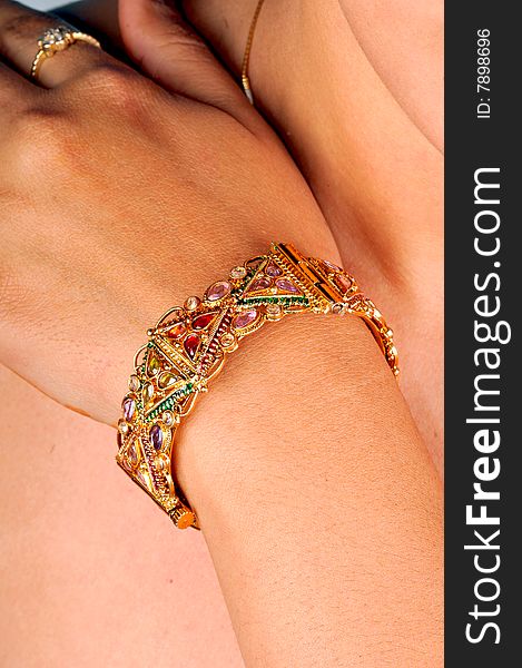 Golden bracelet on models hand.