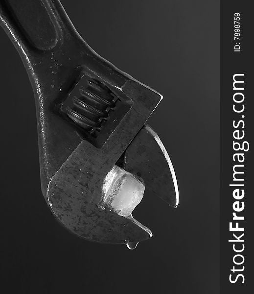 Flat wrench with ice on dark background