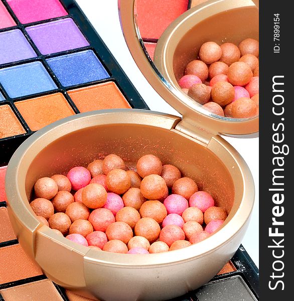 Colored makeup balls and color shades isolated on white background. Colored makeup balls and color shades isolated on white background.