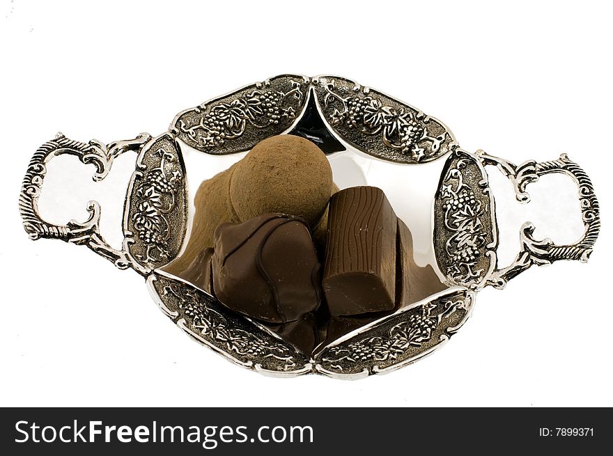 Three sweets that lay on silver saucer. Three sweets that lay on silver saucer