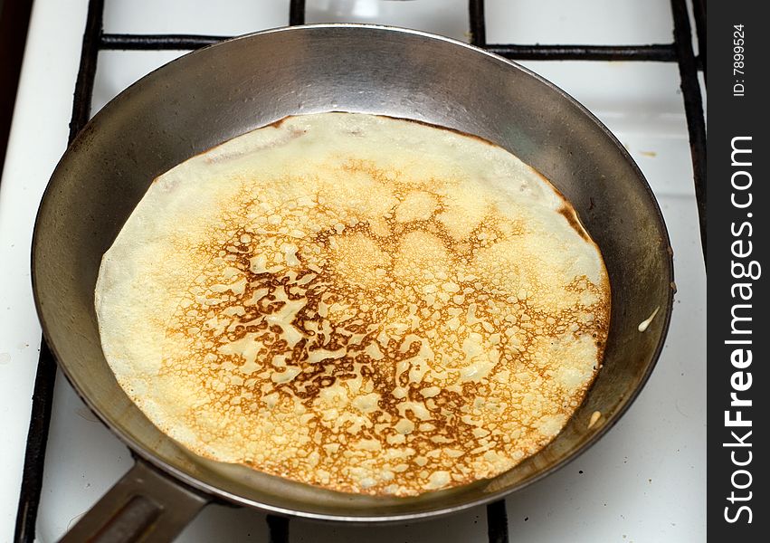 Cooking pancakes in to a frying pan. Traditional food