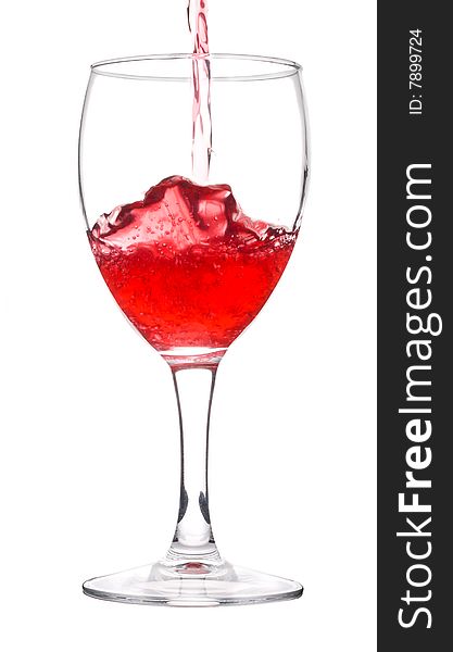 Red wine pouring in glass, isolated on white