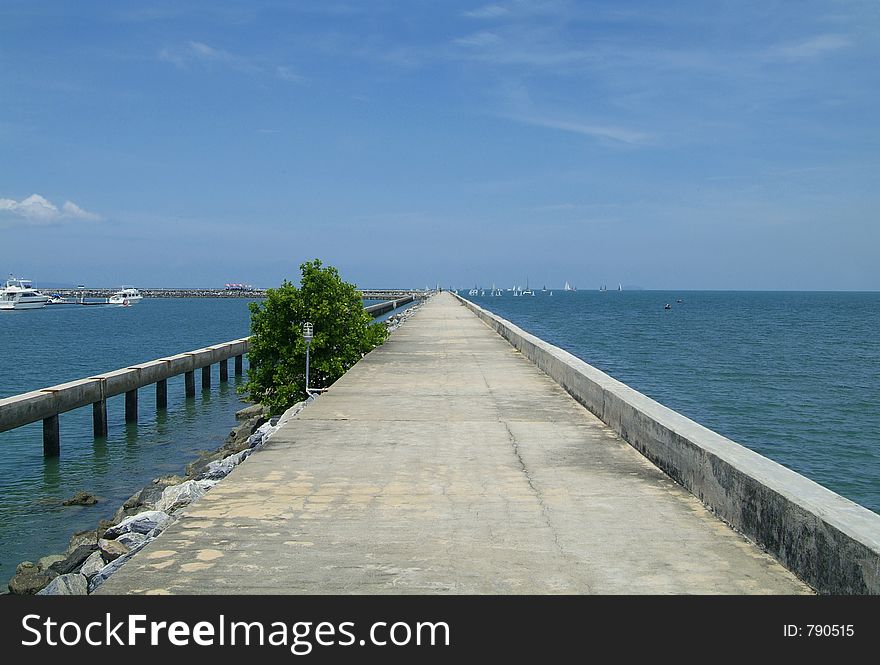 The long cement pier of Ocean Marina in Na Jomtien, Chonburi province, Thailand. The long cement pier of Ocean Marina in Na Jomtien, Chonburi province, Thailand